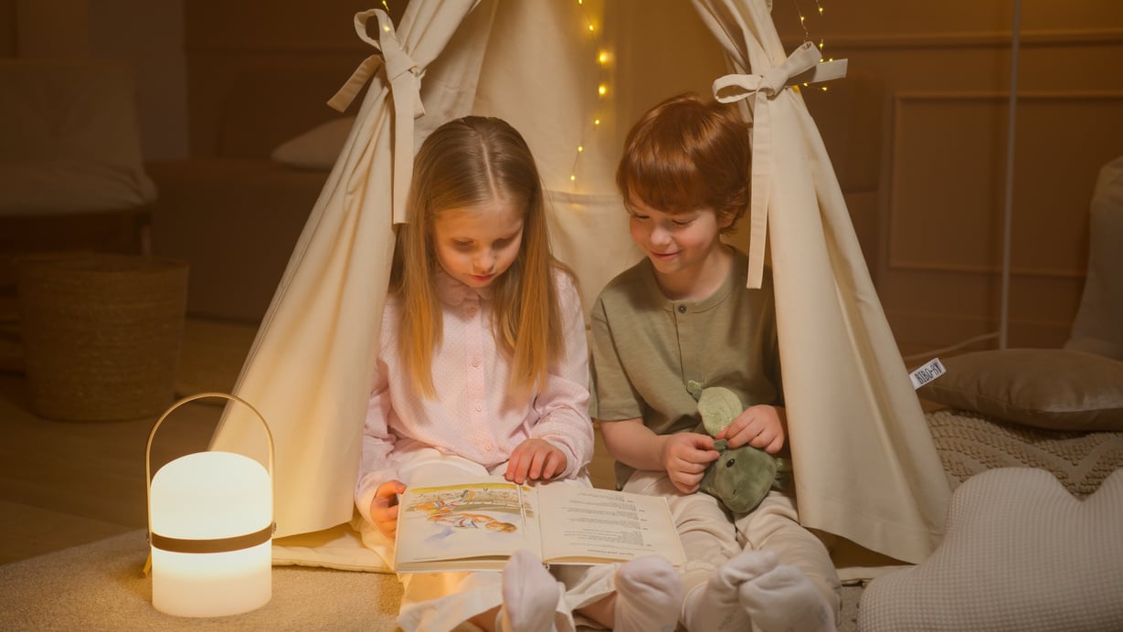 Children Reading a Book Inside a Room